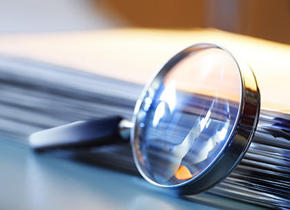 Close-up of magnifying glass and medical records